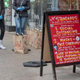 April 2020: a sandwich board lists Trader Joe's COVID protocols, including masks and distancing
